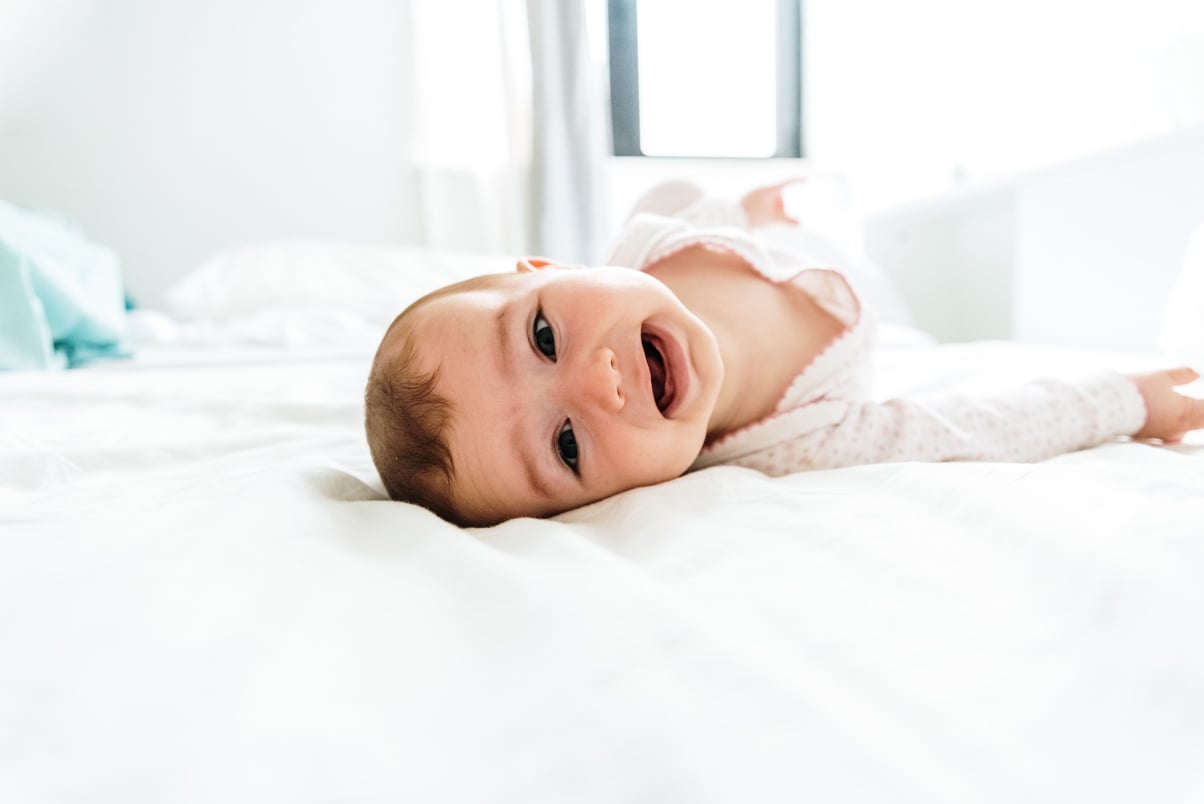 Happy Baby Rolling in Bed